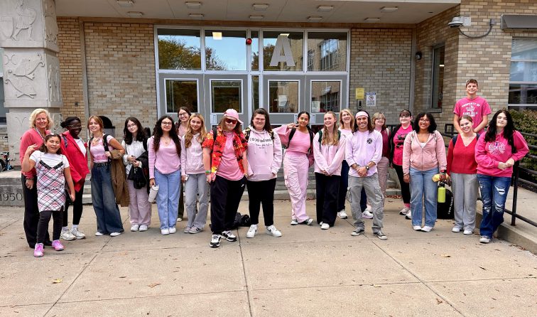 Group of high school students in front of school on Pink Out Day