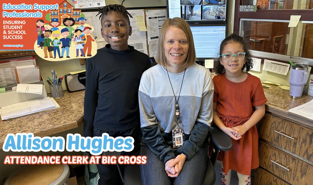 Mrs. Hughes smiling at her desk with student friends