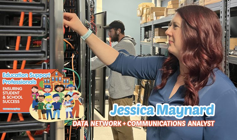 Jess adjusting wires in the server room with an IT assistant behind her, trying to work as well as she does